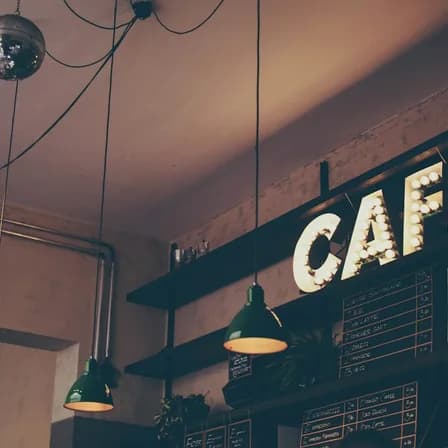 A warmly lit independent café with a handwritten menu and welcoming interior.