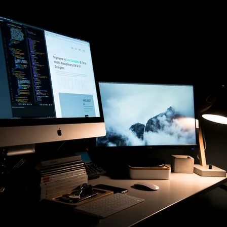 A website development workspace with a live page and code on screen.